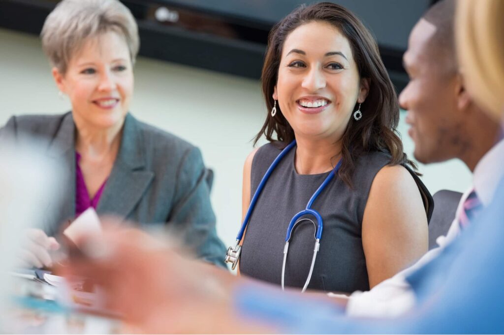 Healthcare executives gathered around a table, strategizing for organizational success.